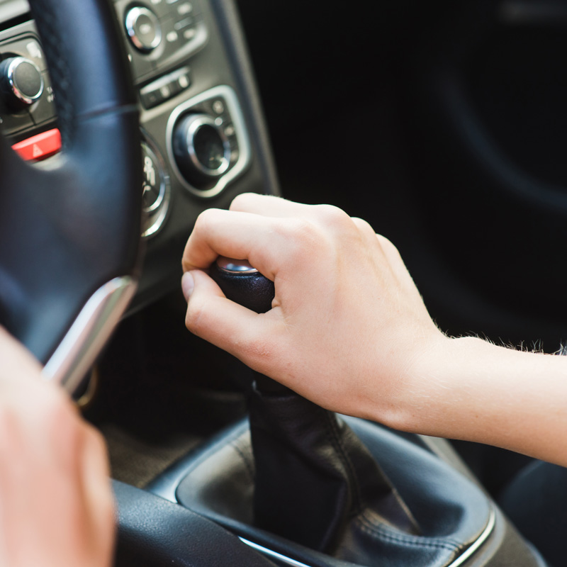 hand on a gear shifter for a car