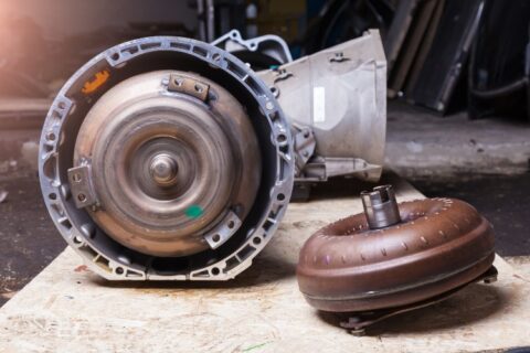 Automatic transmission with detached torque converter on workshop bench